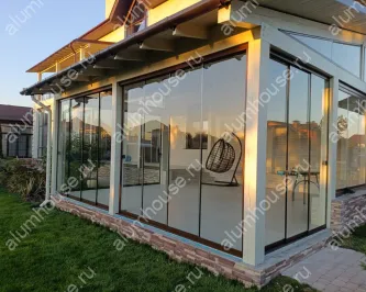Остекление террасы от пола до потолка раздвижной слайд конструкцией