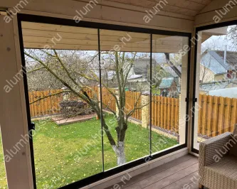 Алюминиевое раздвижное безрамное остекление веранды