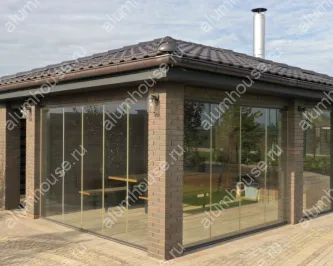 Беседка с безрамным остеклением и зоной барбекю