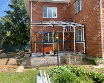 Зимний сад из алюминия пристроенный к углу дома